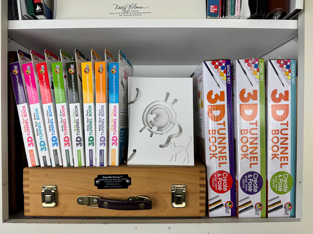 The assembled unpainted DIY 3D Tunnel Book, Cats and Kittens art and craft kit featured on a bookshelf.