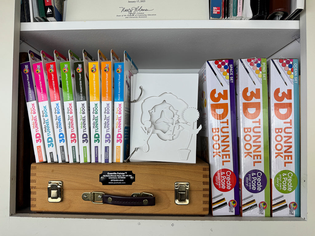 The DIY 3D Tunnel Books Featuring the assembled Medium Size 3D Tunnel Book with Flowers & Mini Pots on a White Bookshelf.